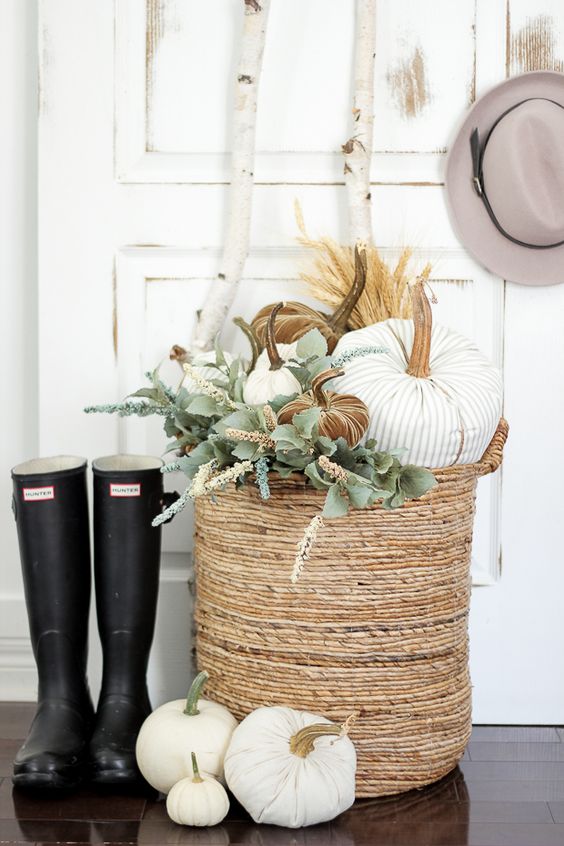 05-a-basket-with-fabric-pumpkins-of-various-colors-and-fresh-greenery-for-cozy-rustic-decor