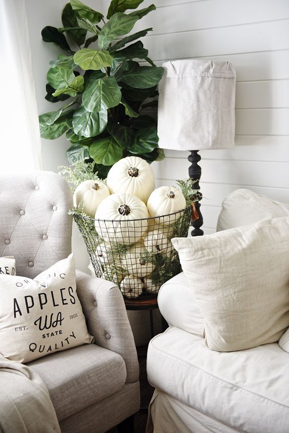 06-a-metal-wire-basket-fulled-with-white-pumpkins-and-greenery-for-a-vintage-inspired-space