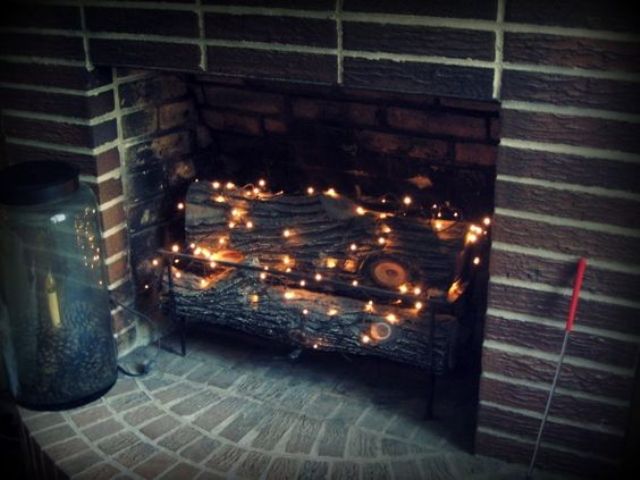 06-put-firewood-and-then-add-a-string-or-two-of-twinkle-lights-in-the-fireplace-to-add-a-soft-glow-to-the-room
