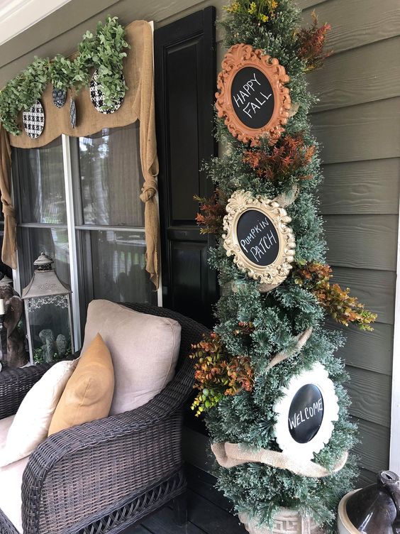 1-a-thanksgiving-tree-with-faux-leaves-and-chalkboard-signs-in-vintage-frames-is-a-stylish-piece-for-indoors-or-outdoors