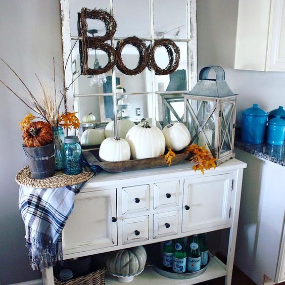 10-a-vintage-console-with-a-trio-of-white-pumpkins-fall-leaves-and-a-plaid-blanket