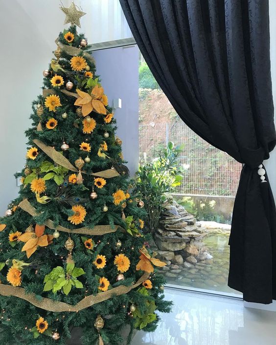 18-a-stylish-rustic-thanksgiving-tree-decorated-with-gold-mesh-ribbons-faux-sunflowers-bright-greenery-and-gold-ornaments