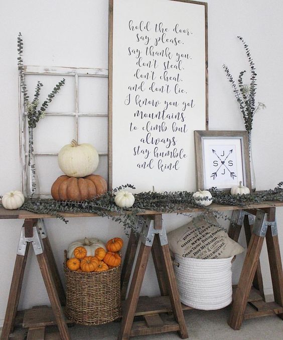 19-a-farmhouse-trestle-table-with-dried-eucalyptus-white-and-orange-pumpkins-signs-and-baskets
