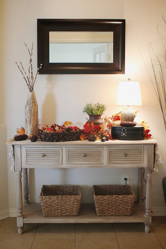 25-a-vintage-rustic-console-table-with-baskets-fall-leaves-pinecones-corn-cobs-and-greenery-in-a-vase