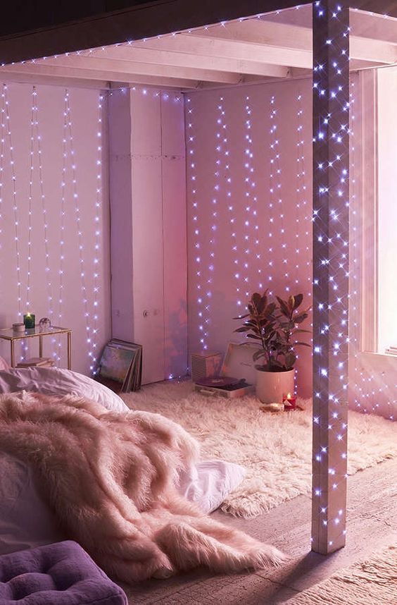 26-galaxy-string-lights-coverign-the-walls-and-beams-of-a-small-bedroom-to-fill-it-with-light