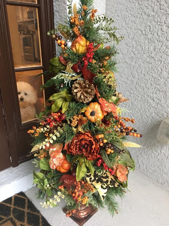 A-thanksgiving-tree-with-faux-blooms-pumpkins-fruits-berries-greenery-and-oversized-pinecones-is-very-lush