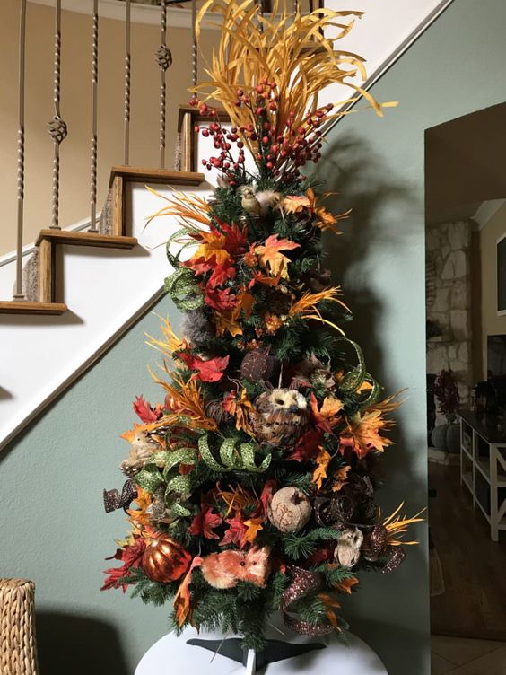 A-thanksgiving-tree-with-leaves-faux-and-fabric-pumpkins-faux-leaves-husks-berries-and-glitter-ribbons