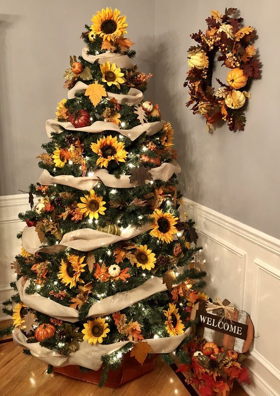 A-thanksgiving-tree-with-tan-ribbons-lights-sunflowers-leaves-and-pumpkins-topped-with-a-sunflower