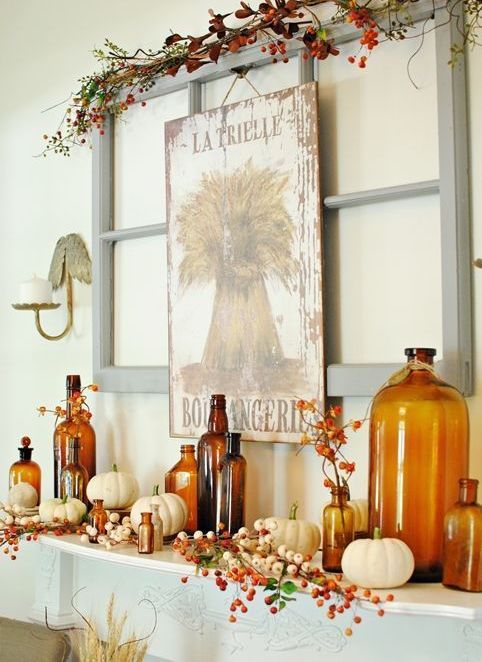A-bright-fall-mantel-with-a-vintage-sign-faux-berries-and-branches-white-pumpkins-and-amber-colored-bottles
