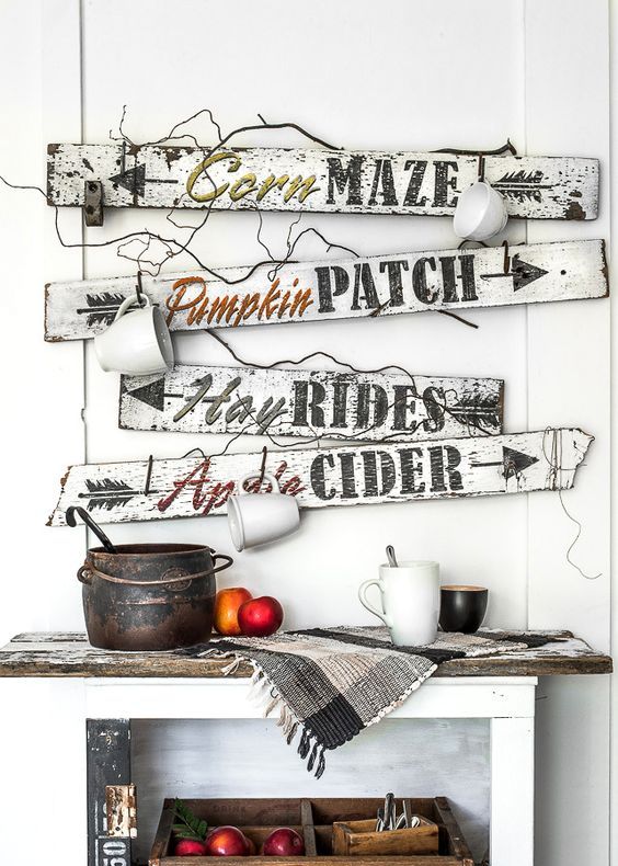 A-bunch-of-white-and-black-fall-signs-with-mugs-hanging-on-them-look-very-relaxed-and-farmhouse-like