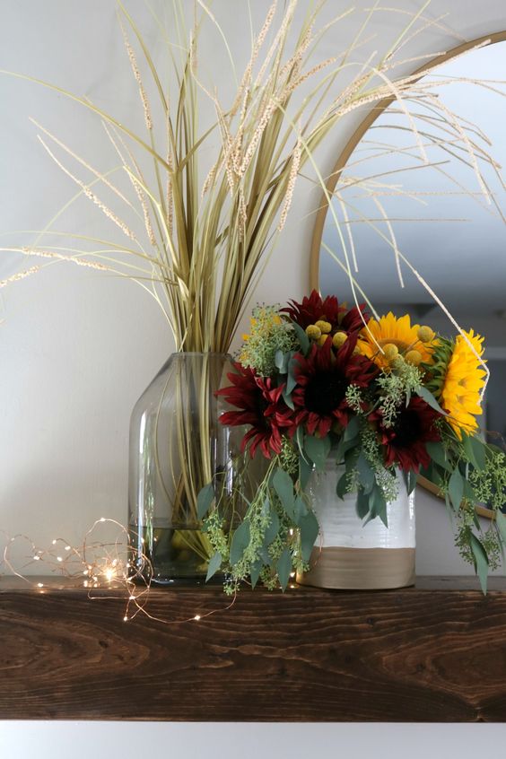 A-chic-fall-faux-flower-arrnagement-with-lots-of-eucalyptus-burgundy-and-yellow-blooms-plus-a-grass-arrangement