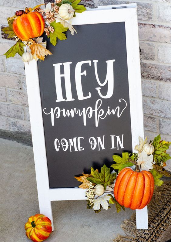 A-cool-black-and-white-fall-sign-decorated-with-faux-leaves-ad-pumpkins-is-a-cool-fall-decoration-for-outdoors