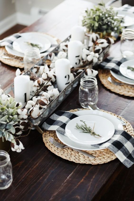 A-cool-fall-centerpiece-of-cotton-greenery-and-candles-woven-placemats-and-plaid-napkins