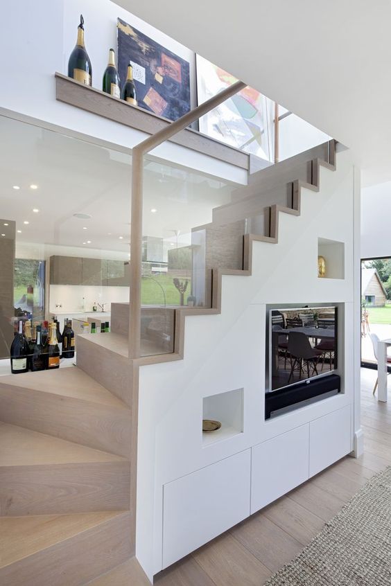 A-couple-of-niches-and-a-tv-built-in-under-the-stairs-to-avoid-using-any-floor-or-shelf-space-for-these-items