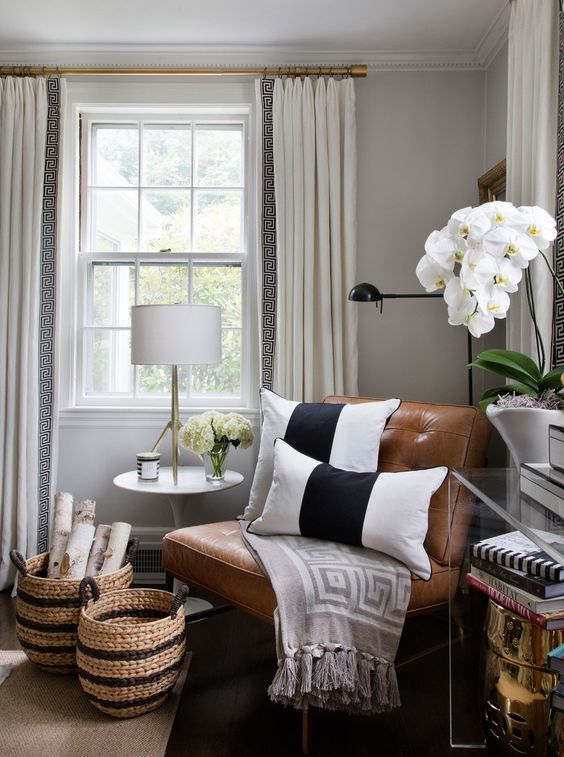 A-cute-nook-with-a-leather-chair-some-orchids-and-matching-striped-baskets-for-storage