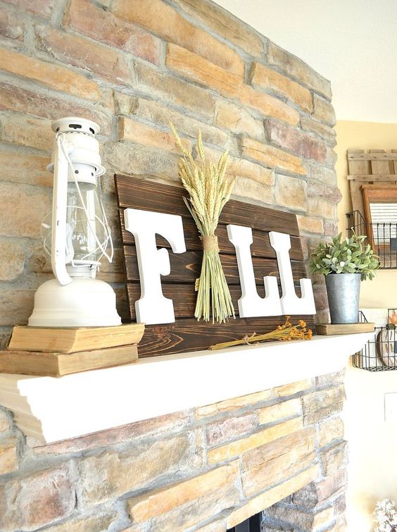 A-dark-stained-fall-sign-with-white-letters-and-a-pack-of-wheat-right-in-the-center-for-a-rustic-touch