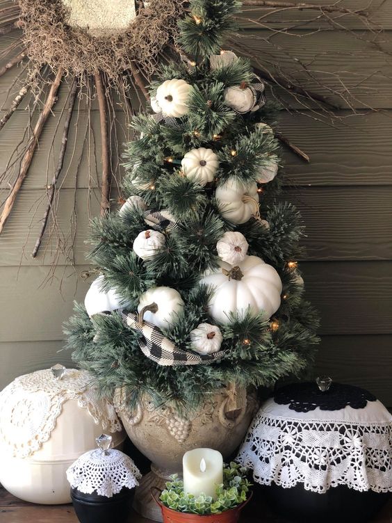 A-mini-fall-tree-with-white-pumpkins-lights-and-a-plaid-ribbon-is-a-stylish-decoration-for-fall-or-thanksgiving