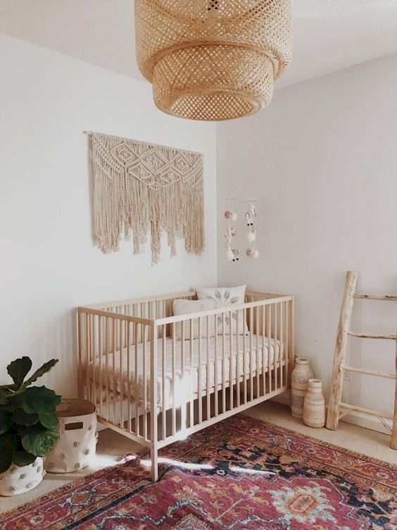 A-minimal-boho-nursery-with-a-large-macrame-a-wicker-lamp-a-boho-rug-some-vases-and-baskets-for-storage