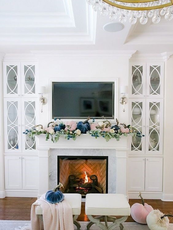 A-pastel-fall-mantel-with-blush-and-navy-velvet-pumpkins-and-fresh-greenery-is-a-cool-modern-idea-1