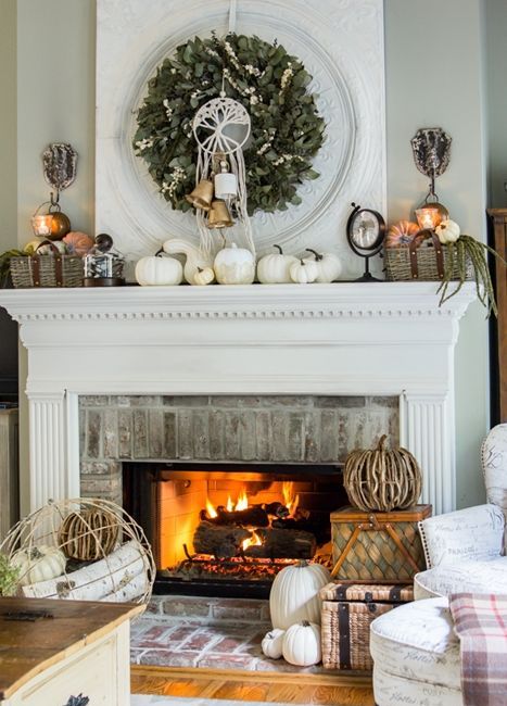 A-rustic-fall-mantel-with-white-pumpkins-baskets-with-faux-pumpkins-a-greenery-wreath-with-bells-and-vine-pumpkins