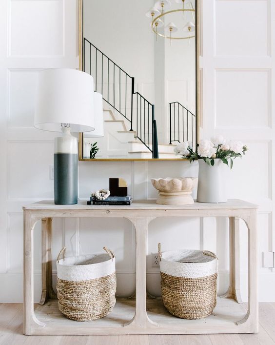 A-simple-wooden-console-table-and-two-matching-baskets-for-storage-are-very-comfy-and-give-a-cozy-feel-to-the-space