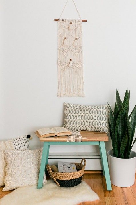 A-small-boho-entryway-with-a-tiny-bench-a-hack-by-ikea-boho-pillows-a-macrame-hanging-a-faux-fur-rug-and-a-basket-for-storage