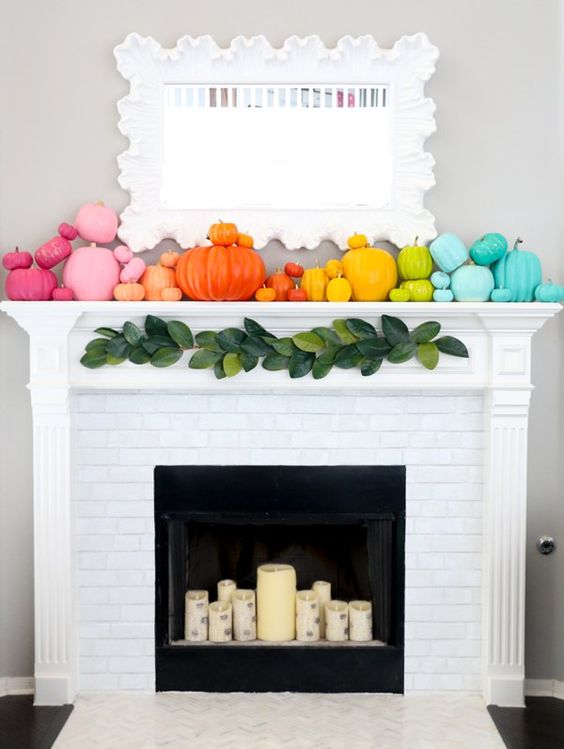 A-super-colorful-fall-mantel-with-super-bright-pumpkins-and-birch-inspried-candles-in-the-fireplace