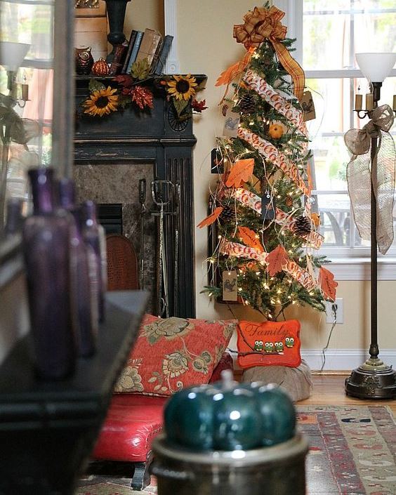 A-thankful-tree-with-bright-printed-ribbons-faux-leaves-pinecones-twine-lights-and-a-large-plaid-bow-on-top