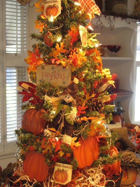 A-vintage-inspired-fall-tree-with-lights-faux-leaves-paper-pumpkins-pinecones-berries-and-plaid-decor
