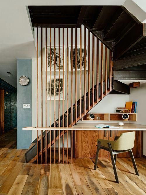 A-working-nook-under-the-stairs-with-sleek-storage-units-and-a-floating-desk-plus-a-chair