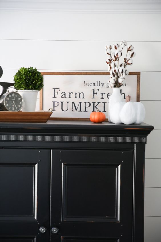 An-elegant-framed-monochromatic-sign-in-a-staiend-wooden-frame-some-cotton-and-fake-pumpkins
