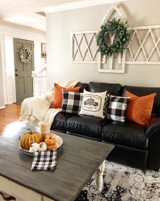 Bright-orange-pillows-and-a-bowl-with-pumpkins-and-candles-are-added-for-a-fall-touch-2