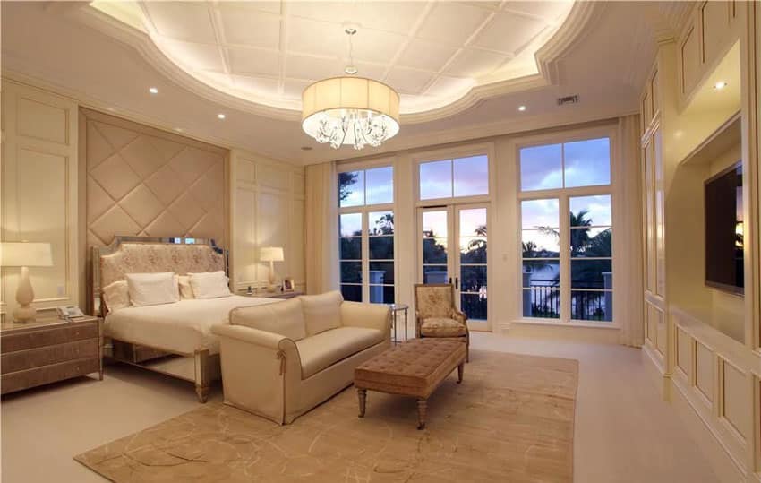 Contemporary-tan-bedroom-with-decorative-tray-ceiling-and-outdoor-balcony