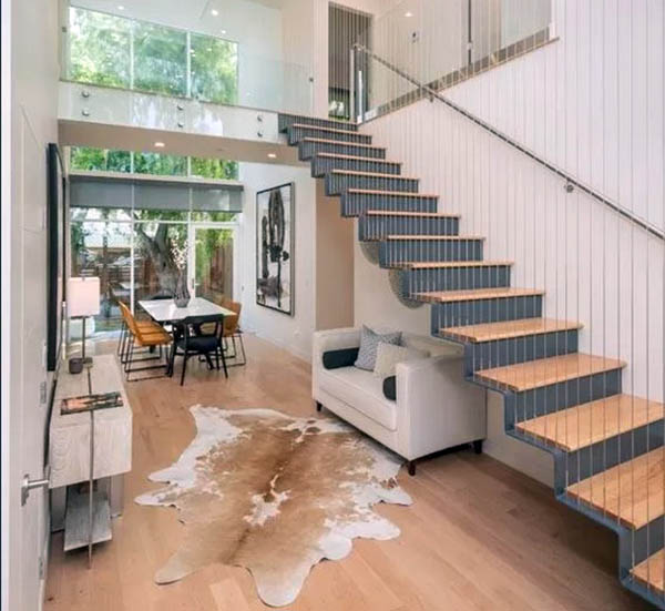 Cozy-sitting-area-under-floating-stairs