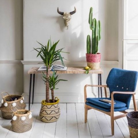 02-a-boho-console-a-cactus-in-a-wrapped-pot-and-some-greenery-plus-a-faux-skull-over-the-table