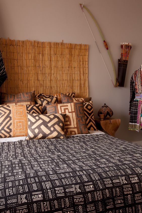 04-this-calm-bedroom-boasts-of-a-cool-headboard-and-warm-colored-traditional-texiles-that-remind-of-africa
