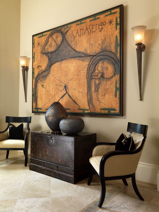 05-warm-colour-palette-and-dark-espresso-furnishings-and-decor-with-2-torch-wall-sconces-flanking-a-large-art-work