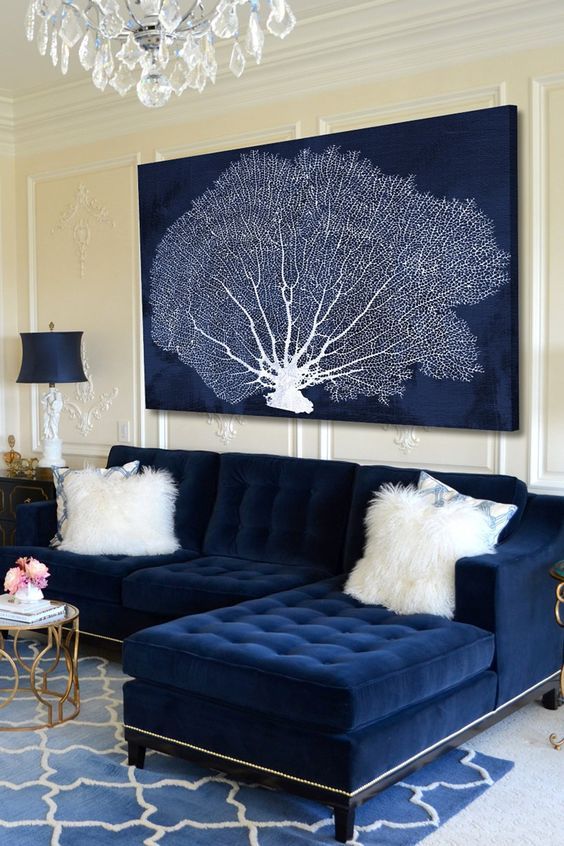 07-a-navy-artwork-with-a-coral-perfectly-matches-the-sofa-and-hints-on-the-ocean-location-of-the-home