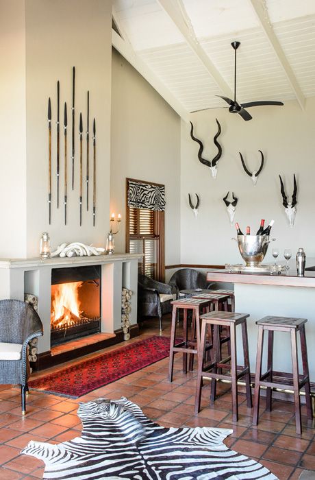 08-buttermilk-walls-spears-and-a-faux-zebra-rug-create-an-ambience-here