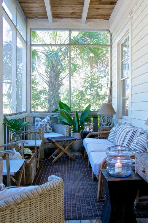 1-a-pretty-tropical-screened-porch-with-wicker-furniture-printed-pillows-potted-plants-candle-lanterns-and-lamps-is-cool