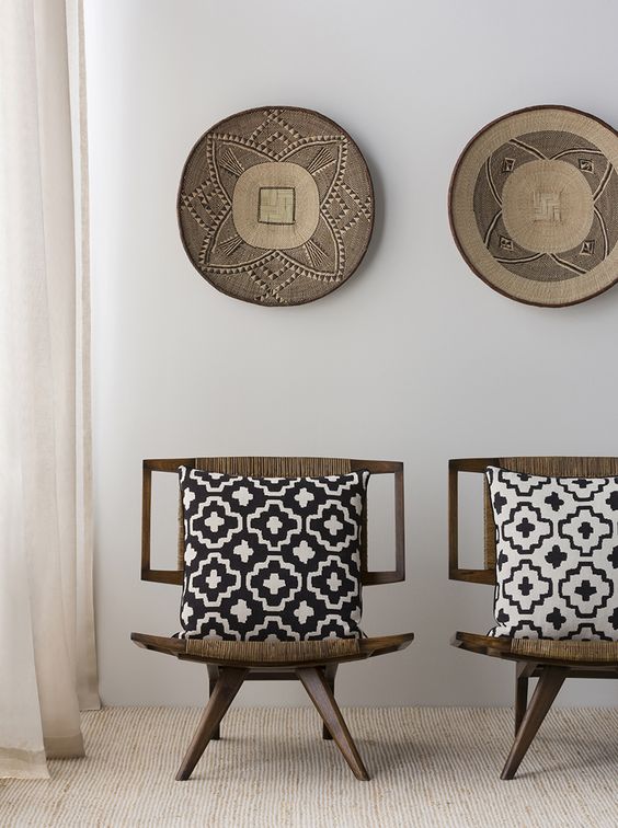 11-dark-wood-chairs-upholstered-with-ethnic-woven-fabrics-and-matching-pottery-on-the-wall