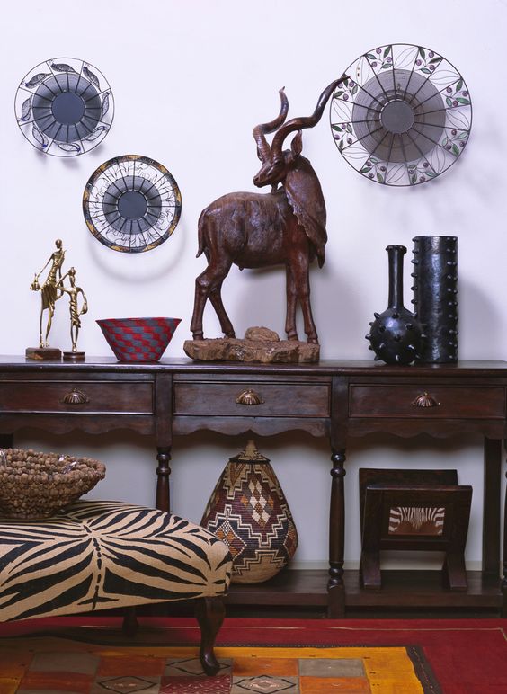 15-carved-console-table-with-a-zebra-printed-ottoman-and-african-artworks