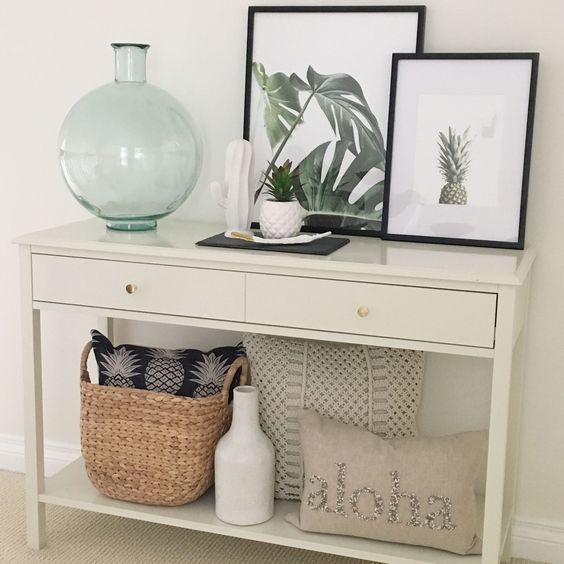 16-a-summer-console-with-artworks-with-a-pineapple-and-tropical-leaves-a-potted-plant-a-basket-with-a-pineapple-pillow-and-a-tropical-feel