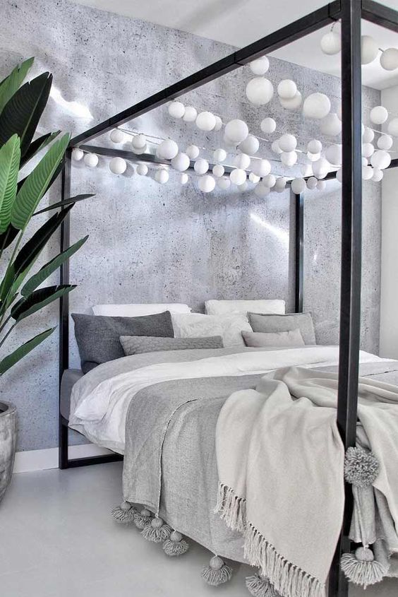 18-a-black-canopy-bed-with-white-bulb-garlands-over-it-is-a-fun-idea-to-add-light-without-any-lamps-around