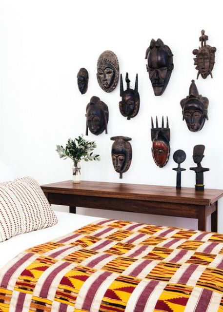 20-a-collection-of-african-carved-masks-on-a-bedroom-wall-for-a-statement