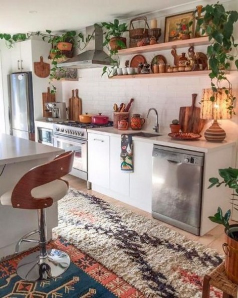 A-boho-space-with-boho-chic-rugs-potted-greenery-and-much-wood-and-plywood-in-decor