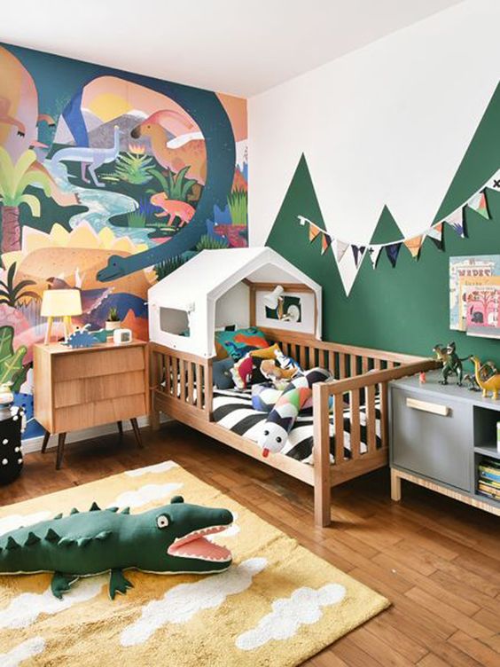 A-bright-and-fun-jungle-themed-kids-bedroom-with-a-bold-artwork-a-house-bed-and-colorful-jungle-inspired-toys