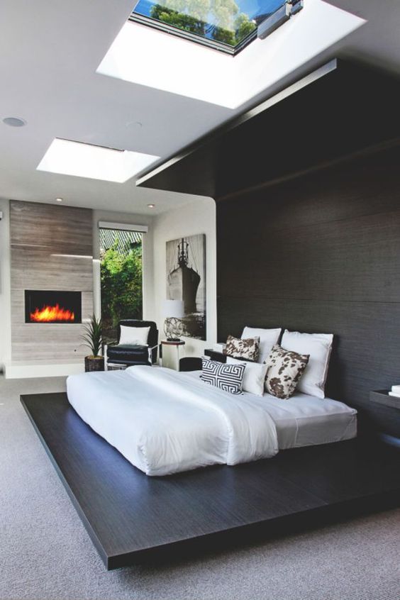 A-dark-stained-platform-continued-up-to-the-headboard-and-further-to-create-a-cozy-curled-up-look