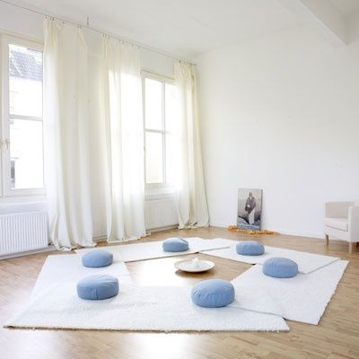 A-home-meditation-room-with-white-rugs-and-blue-cushions-and-much-light-and-air