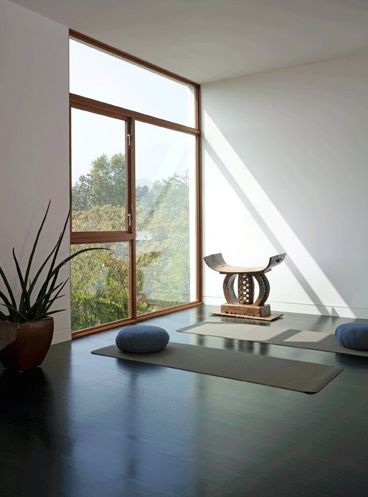 A-minimalist-meditation-room-with-a-large-window-for-views-and-some-mats-and-cushions